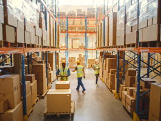 Retail Warehouse full of Shelves with Goods in Cardboard Boxes, Workers Scan and Sort Packages, Move Inventory with Pallet Trucks and Forklifts. Product Distribution Logistics Center. Elevated Shot