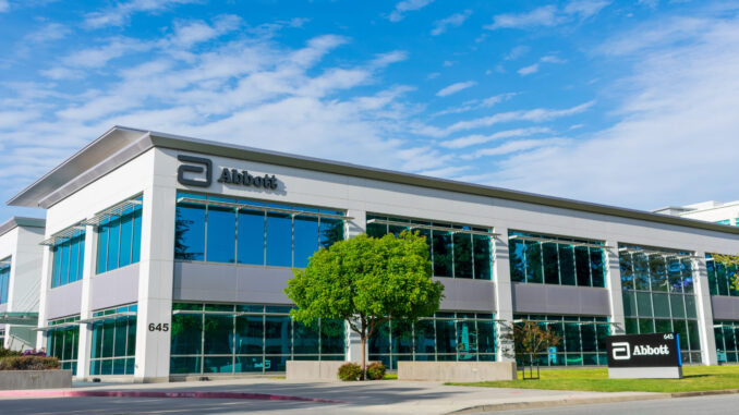 Abbott Laboratories modern office exterior under blue sky. Abbott Laboratories develops a broad line of health care products and services.